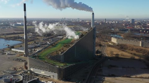 Copenhagen, Denmark - March 05, 2021: Aerial drone view of Amager Bakke, a waste to power plant with a ski slope on top.