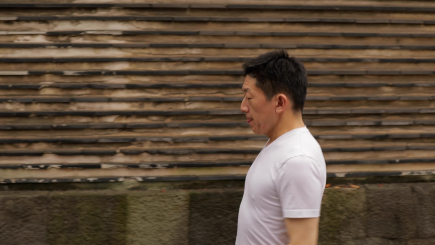 Middle-aged Japanese man exercises in a park in Tokyo Japan