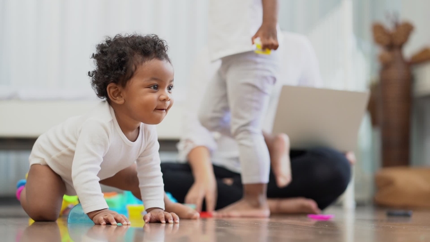 Happy African American Little baby boy crawling and looking for some thing to learn Royalty-Free Stock Footage #1068509393