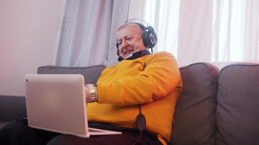 Happy elderly man with headset having video call with family. High quality 4k footage | Shutterstock HD Video #1068509501
