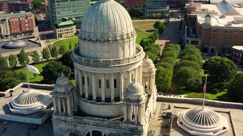 Aerial panning shot of state government office in city on sunny day, drone flying over buildings - Providence, Rhode Island