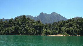 Motorboat passing by beautiful Khao Sok Lake overlooking picturesque landscapes. Boat camera shot view. Beautiful nature and traveling 4K concept video.