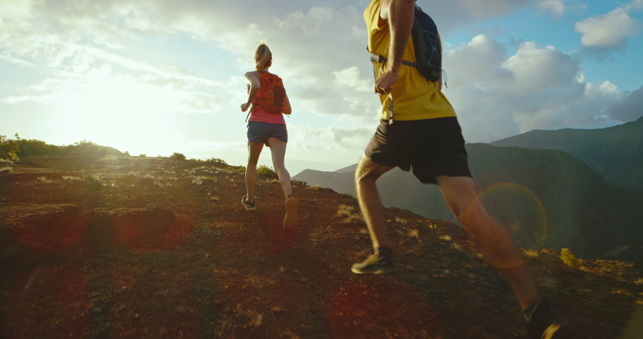 Running on mountain trail at sunset, epic adventure, healthy fitness lifestyle, training for marathon | Shutterstock HD Video #1068525884
