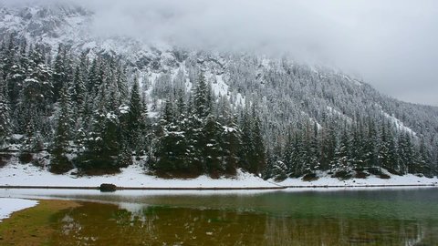 Amazing winter landscape with snowy mountains and clear waters of Green lake (Gruner see), famous tourist destination in Styria region, Austria