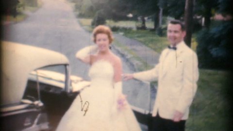 TRENTON, NEW JERSEY, JULY, 1960: A beautiful bride and groom take off in their getaway car after their wedding in the summer of 1960.