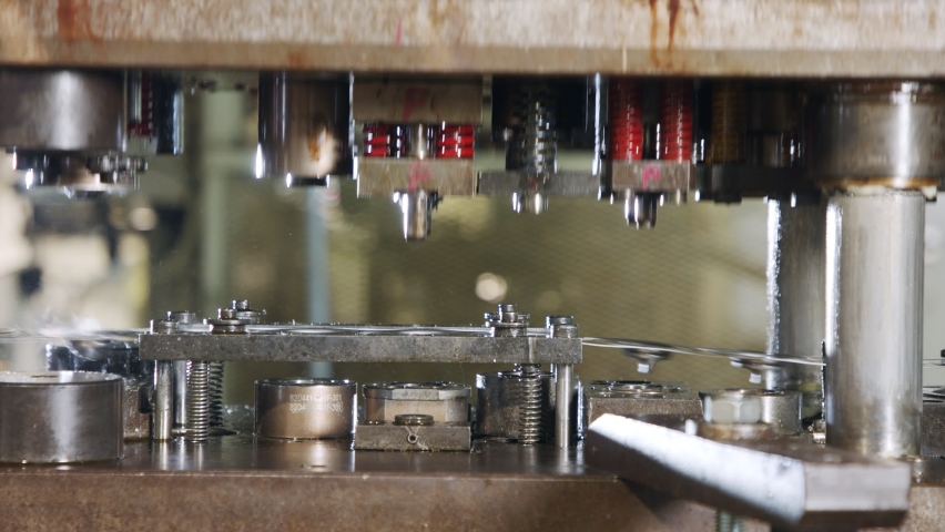 Close up of a punch press forming metal parts in a production line Royalty-Free Stock Footage #1068537356