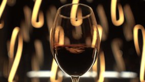 The movement of red wine in a glass, standing against the background of night lights, close up - Powered by Shutterstock - Get 15% off with code: PIKWIZARD15