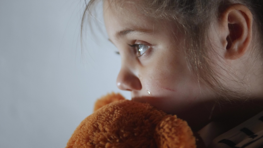 Domestic violence. little girl with bruises and abrasions on her face punished in the corner crying tears. domestic kid abuse fear concept. autistic child is punished and beaten afraid of fear | Shutterstock HD Video #1068541424