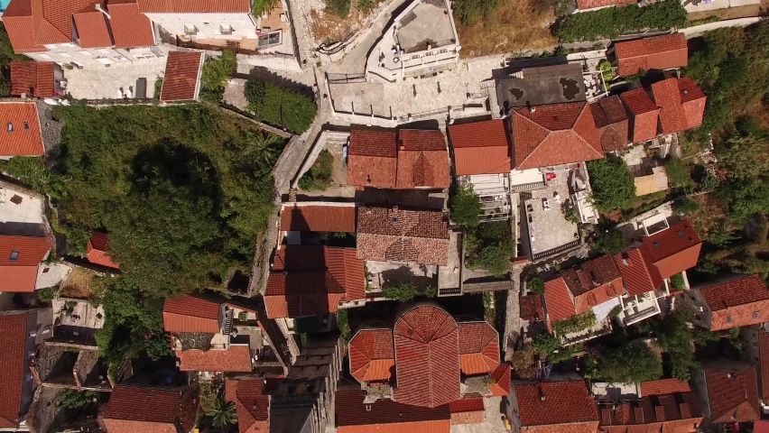 Aerial view of buildings of the old town of Perast, mountains, sea, pear and boats near it  | Shutterstock HD Video #1068544664