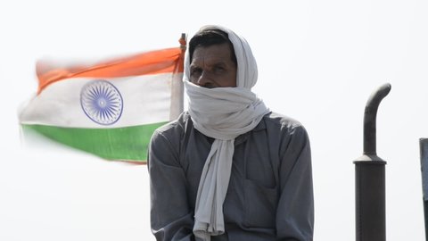 duhai, Ghaziabad, Uttar Pradesh, India, March 6 2021:farmer with indian flag during protest near Duhai toll plaza, Farmers Protest entered in 100th day, Farmer Protesting against new agriculture laws.
