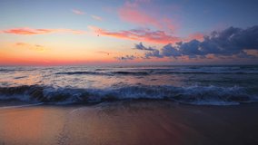 Ocean waves and beautiful island beach. Color sea sunrise with dramatic clouds, 4K video