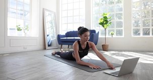 Asian women learn yoga online in video conferencing, Fitness Instructor, Yoga online, Video call on laptop.