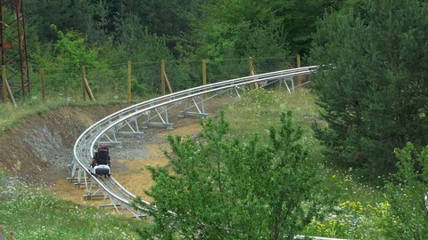 Bansko, Bulgaria - 20 Aug, 2019: People on the Pipe Mountain coaster, a mountain ride and summer attraction in Bansko, Bulgaria