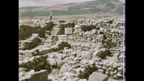 1960s: People walk through ancient ruins of city of Hazor. Map of Jerusalem, Shechem, Gerar, Beer-Sheba, Mamre, Jericho, Sidon, Tyre, Hazor. Canaanite statue in museum. Vase and small figurine.