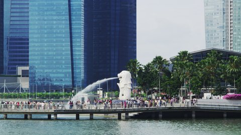 SINGAPORE, SINGAPORE - MAY 24, 2013: The Symbol of Singapore, the Merlion with Financial District Buildings at the Background