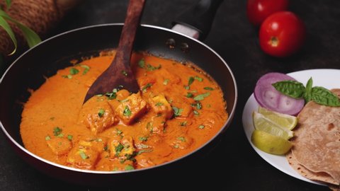 Cooking tomato Paneer curry, Paneer masala in Delhi, Mumbai. North Indian vegetarian side dish  butter paneer made using cottage cheese, Indian spices. 4K video, footage Kerala