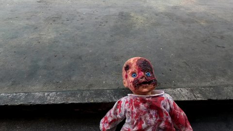 Creepy bloody doll Halloween concept, Close up of children Ghost mystic doll, Scary horror baby doll video footage