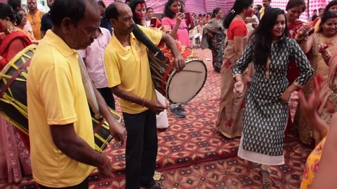 Traditional Dhakis (drummers) playing Dhaak while Bengali Women  Dances during Vijaya Dashami in Durga Puja Festival. It is a ritual to bid farewell to Goddess Durga.

Delhi - India 
10th Oct 2019