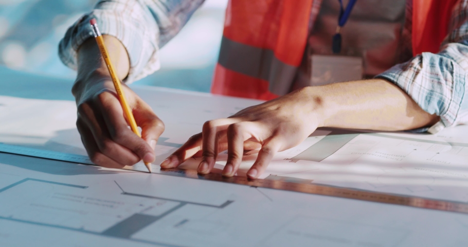 young inspired male architect african maerican foreman engineer drawing new deisgn of civil construction inside office.