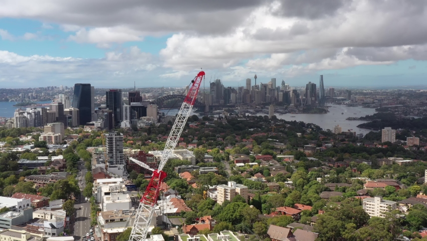 Constuction crane in view of Sydney city CBD high-rise towers – aerial 4k.

