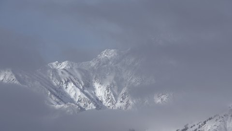 Snow mountains with clouds and mist is beautiful landscape by time-lapse in Hakuba, Japan.