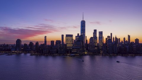 Illuminated Urban Skyline of Lower Manhattan, New York at Blue Hour in the Morning. Aerial Hyper Lapse, Time Lapse. United States of America. Drone Flies Sideways