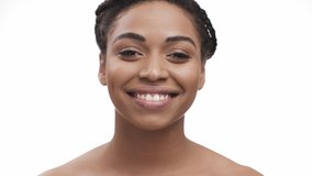 Pretty african american woman sending blow kiss to camera and smiling, white studio background, slow motion - Powered by Shutterstock - Get 15% off with code: PIKWIZARD15