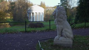 Pavlovsk Park, statue of marble white lion in front of Temple of Friendship pavilion, St. Petersburg, Russia.