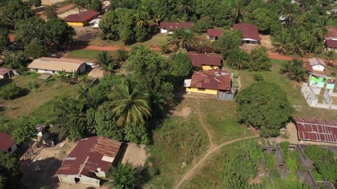 Aerial Kakata village tropical homes Liberia Africa. Homes, business and nature near Monrovia Liberia. Tropical forest landscape. Poor low income poverty environment.
