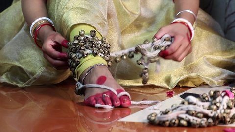 Classical Indian Girl Kathak Dancer In Traditional Dress Or Costume Tie Ghungroo Ghungru Or Noopura Which Is A Musical Anklet To The Feet Painted With Red Dye Altha Alah Mahavar Or Alta