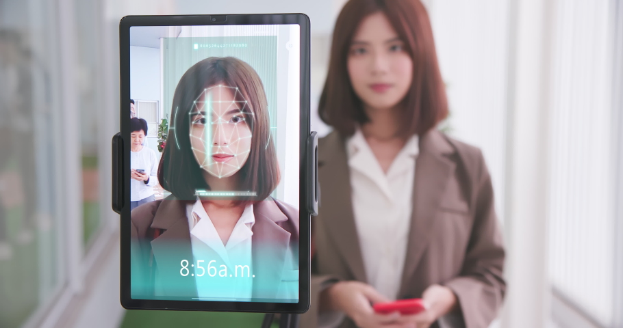 Facial recognition concept - Asian businesswoman using face scanner to clock in work and check body temperature | Shutterstock HD Video #1068614378