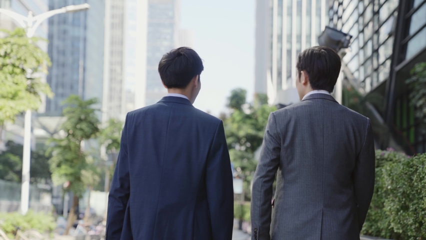 rear view of two asian business men talking walking in downtown of modern city Royalty-Free Stock Footage #1068615755