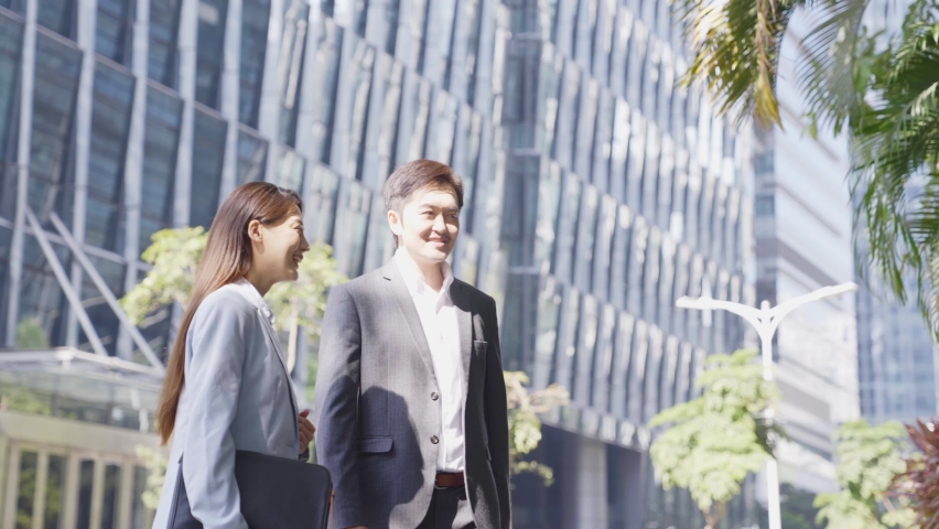 asian business associates shaking hands and talking in the street in downtown of modern city Royalty-Free Stock Footage #1068615773
