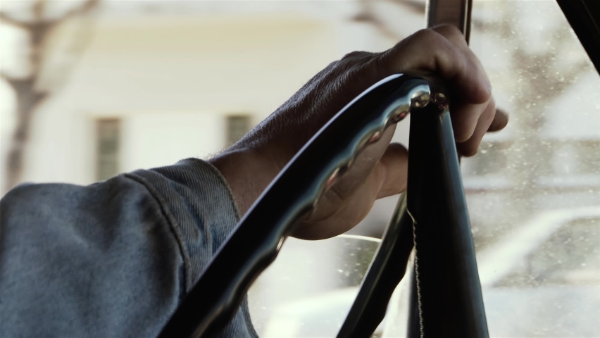 Male Hands On Steering Wheel in an Old Pickup Truck. Close-Up. 4K Resolution.