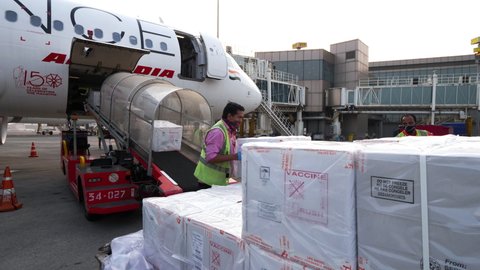 Mumbai, Maharashtra, India - 25 February 2021: Workers loading COVID Vaccines in the aircraft cargo hold for transportation.