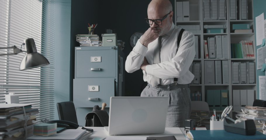 Stressed angry businessman smashing his laptop with a baseball bat, job burnout concept | Shutterstock HD Video #1068630155
