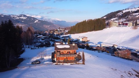 Aerial footage of Swiss Mountain Chalet at sunset. Series of videos for B-roll and storytelling. Snowy mountains, Swiss Alps view 
