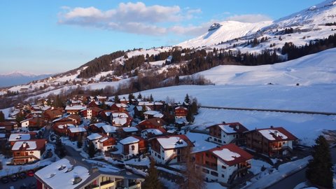 Aerial footage of Swiss Mountain Chalet at sunset. Series of videos for B-roll and storytelling. Snowy mountains, Swiss Alps view 