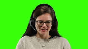Close Up Call Center Female Agent Customer Service On Green Screen. Woman working as a call center agent on a green screen background. Close up shot - Powered by Shutterstock - Get 15% off with code: PIKWIZARD15