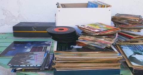 Modugno, Italy - 20 september 2020: Buyer looks at LPs and single vinyls for sale at a stall