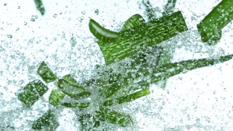 Super slow motion of aloe vera pieces flying up in the air with water splashes. Filmed on high speed cinema camera, 1000 fps.