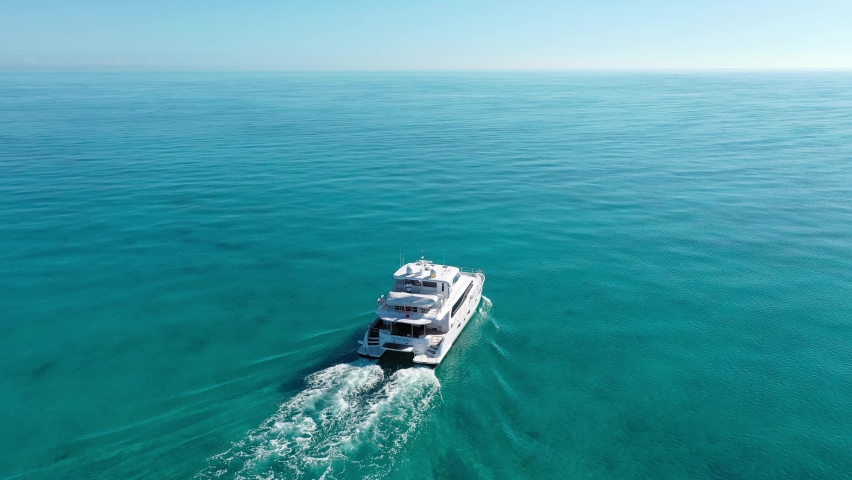 Power Catamaran Cruising alone in Shallow Clear Water | Shutterstock HD Video #1068648788