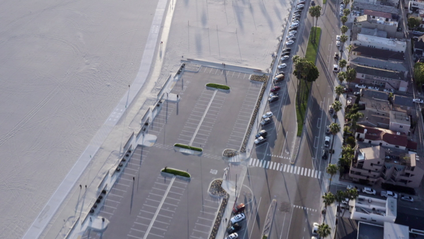Aerial Forward: Long Wide Sandy Beach Between Neighborhoods And Water Under A Glorious Sunset Sun
