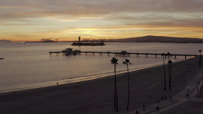 Aerial Forward: People At The Beach Exploring The Area