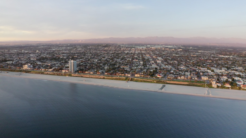Aerial Pan Right To Left: Relaxing Beach By The City