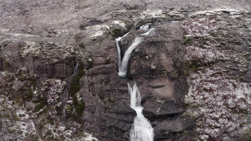 Aerial Backward: The Winding Road With Waterfalls And Mountains
