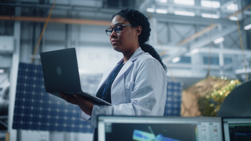 Portrait of Brilliant Female Engineer Confident and Focused Thinking, working at Aerospace Satellite Manufacturing Facility. Top World Scientist Doing Science and Technology Research in Space Program Royalty-Free Stock Footage #1068654005