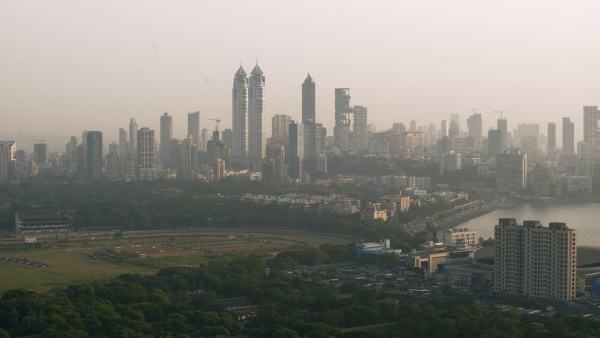 Pan Across Cityscape With Towering Skyscrapers And Harbor On A Humid Sunny Day