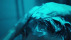 4k Close-up of hair with lather from the use of shampoo. low key. dark neon blue light, Young woman takes a shower. care for long curly hair. hair mask application  - Powered by Shutterstock - Get 15% off with code: PIKWIZARD15