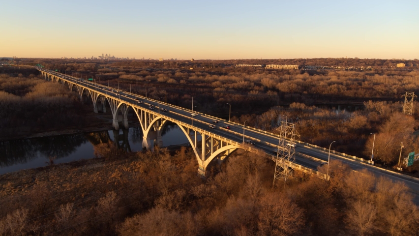 Dramatic aerial view of Mendota Bridge and surrounding area, during golden hour